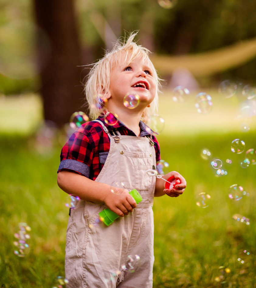 Small happy child having fun in a field.