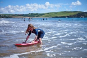Young girl surfing in Devon