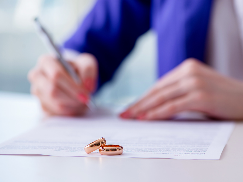 woman signing prenuptial agreement - prenuptial agreement solicitors